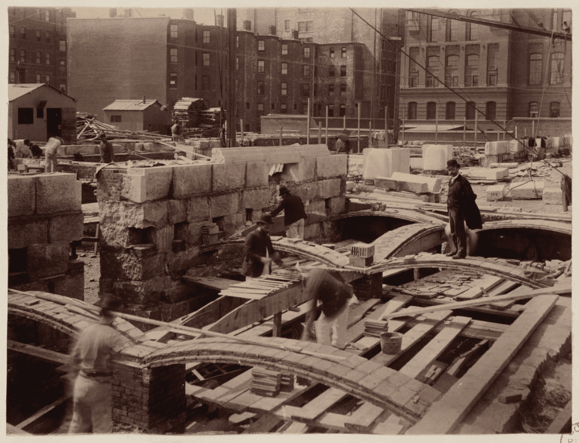 Rafael Guastavino stands on recently laid tile arch along Boylston Street, construction of the McKim Building