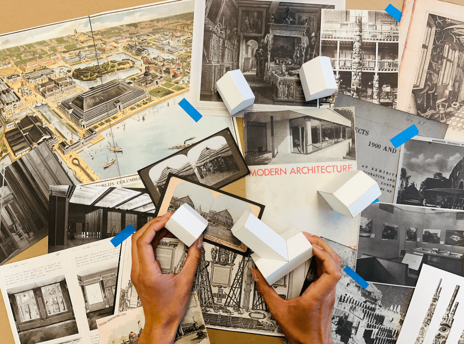 Archival images of architectural exhibitions arranged on a desktop